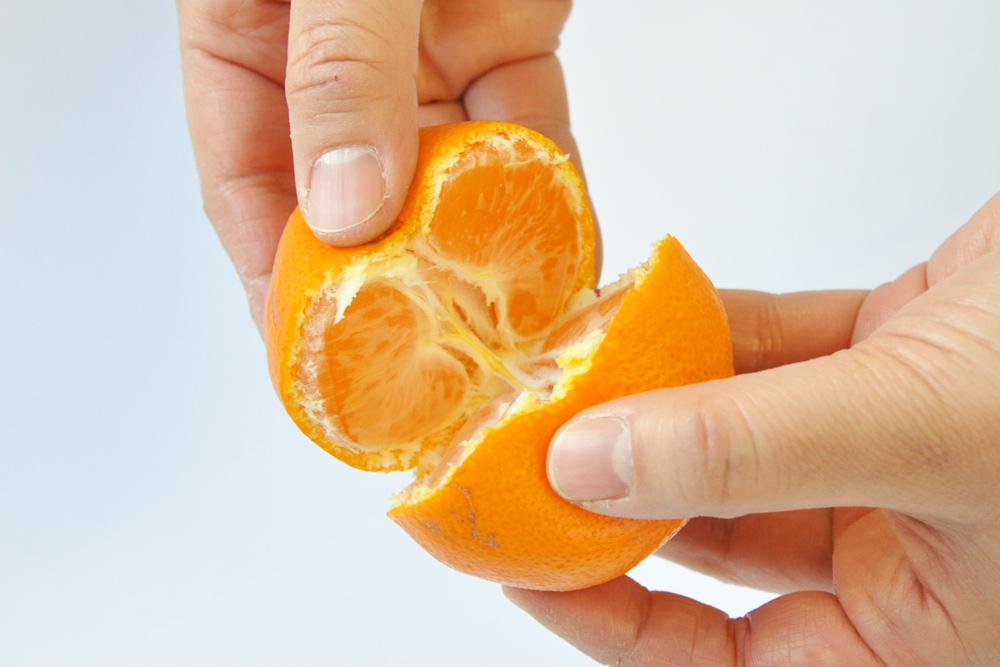 Divide the mandarin orange in half